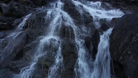 mountain waterfall, on rocky slopes