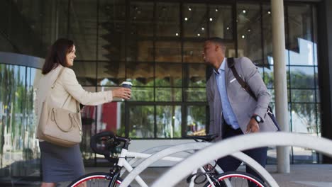 diverse businessman and businesswoman arriving to work in modern office building