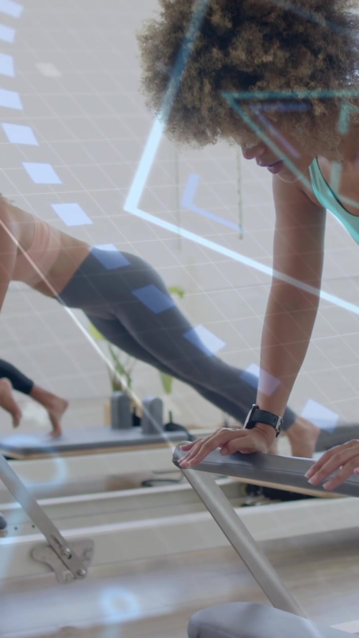 Women exercising on reformer machines with digital data overlay animation