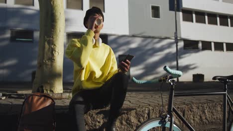 transgender adult  drinking coffee in the street