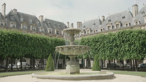 fountain at place des vosges, paris, france