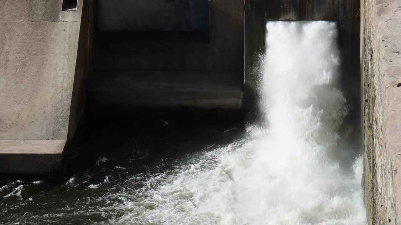 Sequential water release from a dam structure