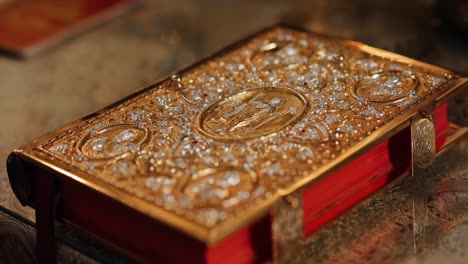 the holy book of the bible in a golden binding on the throne in a church or temple