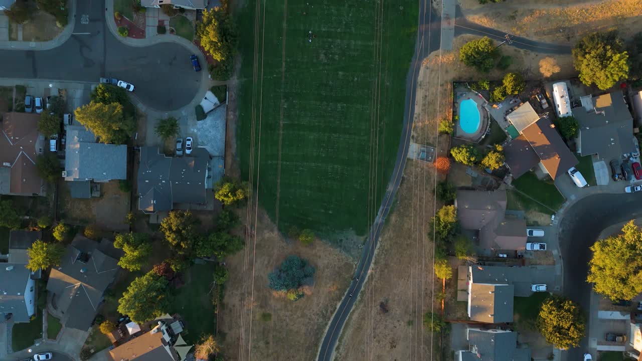 Aerial overhead shot of a trail running beneath power lines, capturing the natural landscape intersected by infrastructure.