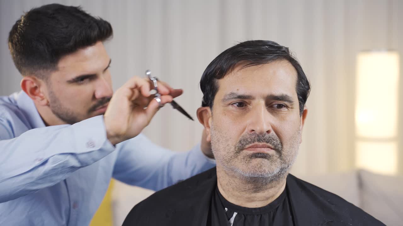 The old man's hair is shaved at home.