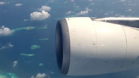 atolls of archipelago of maldives from above and engine aircraft