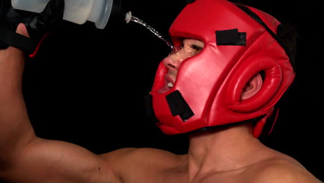 tough boxer pouring water over his face