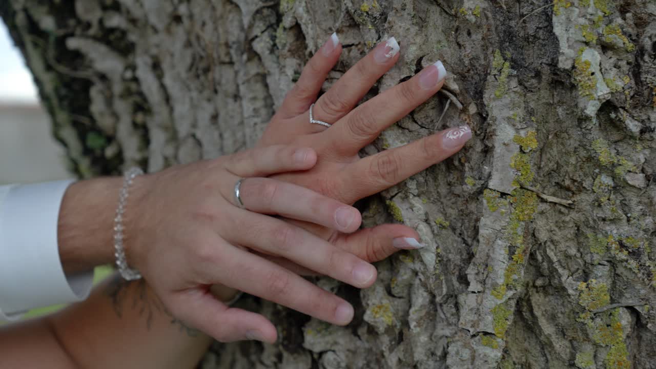 Slow motion shot of a newly married couples wedding bands on their hands