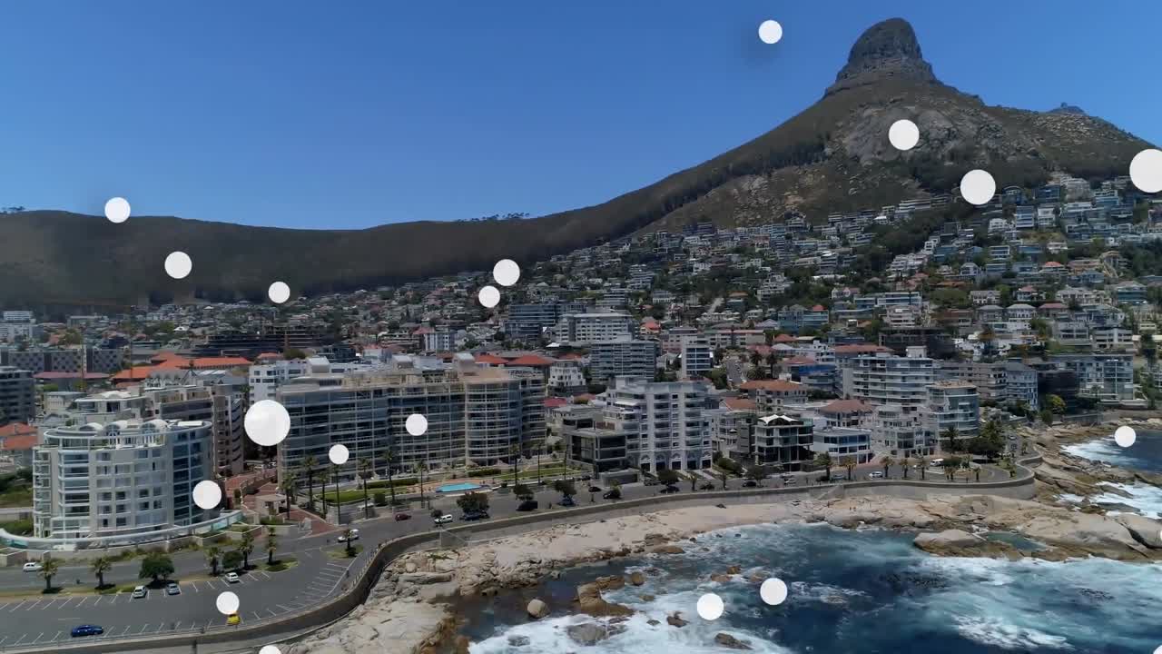 composición digital de múltiples manchas blancas flotando contra la vista aérea del paisaje urbano