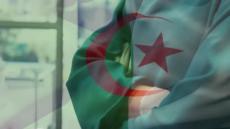 Animation-of-flag-of-algeria-over-caucasian-female-doctor-with-face-mask