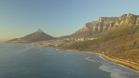 Scenic-wide-aerial-Drone-view-of-coastal-Oudekraal-Nature-Reserve,-Twelve-apostles-mountains,-South-Africa