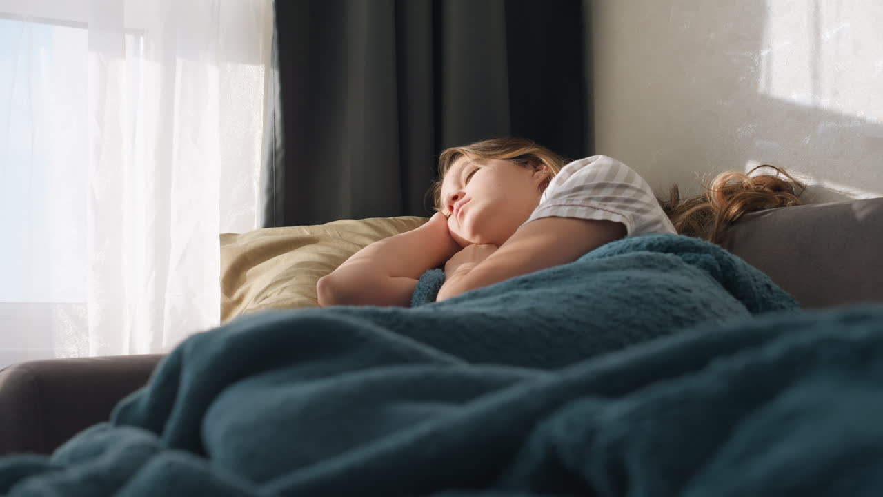 Calm Female Enjoying Quiet Natural Environment, Peaceful Lady Finds Serenity While Reclining Comfortably Amidst Soothing Natural Surroundings Under Soft Illumination With Cozy Covering