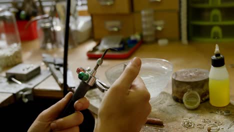 jewelry designer working with wielding torch 4k