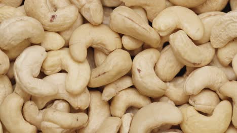 smooth camera movement over a handful of cashew nuts.