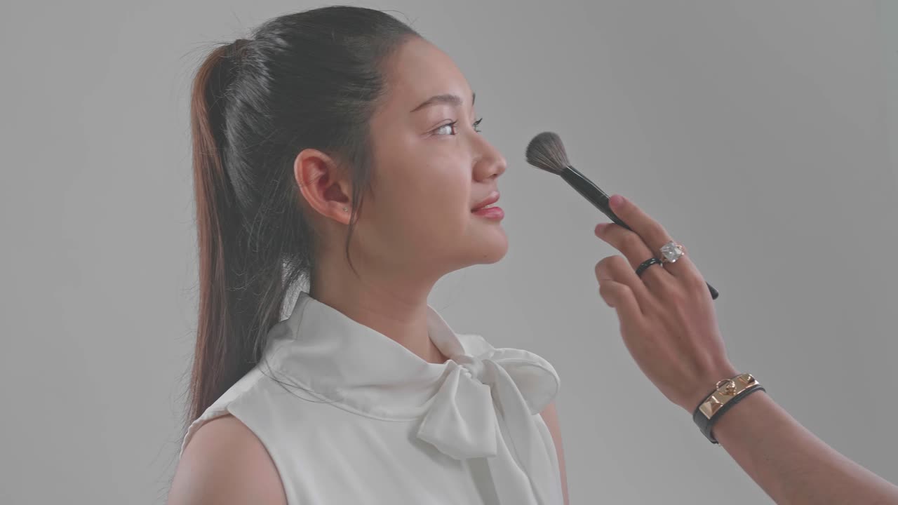 Backstage Of The Photo Shoot: Make-Up Artist Applies Makeup On Beautiful Asian Model