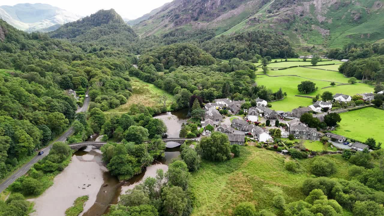 Flyover drone shot of Grange in Borrowdale. A scenic English village near Derwent Water surrounded by stunning fells