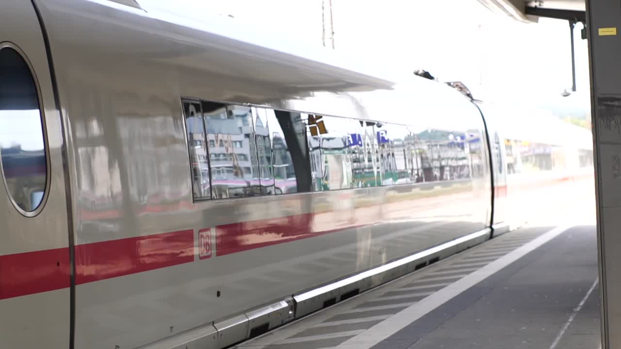 A sleek ICE train departs from a German train station, representing modern transportation, efficiency, and travel. Perfect for projects focused on urban mobility and technological advancement.