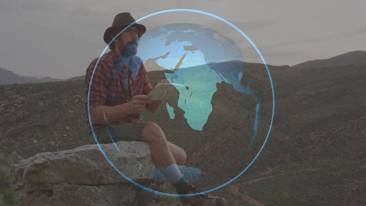 Homem começando a escrever em um livro numa saliência rochosa, sobreposição de globo giratório com mapa em movimento para planejar viagens.