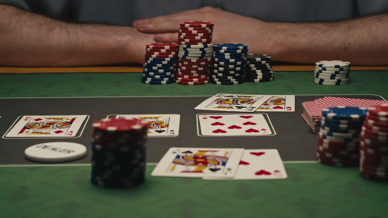 A person playing poker at a casino table