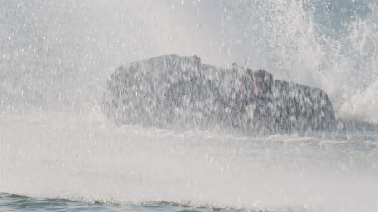 Chisinau, Moldova - June 17, 2025: A man in a black life vest riding a black jet ski at high speed across a calm body of water