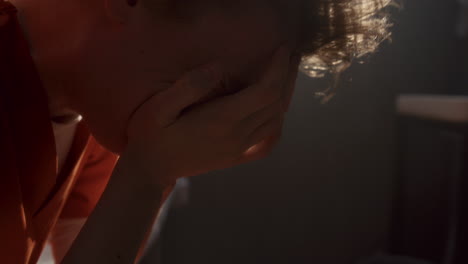 female inmate crying in frustration and hopelessness in prison cell