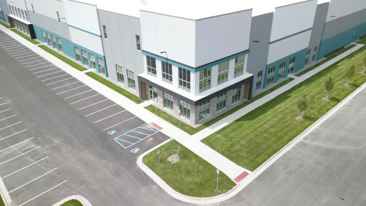 Drone Ascends Above Modern Suburban Office Building