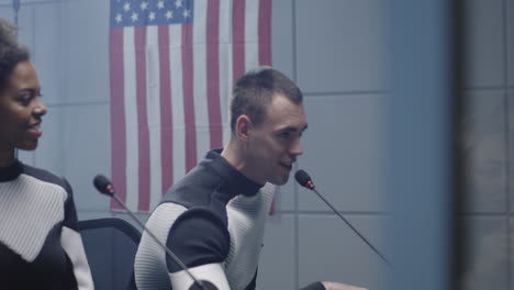 astronauts in conference room