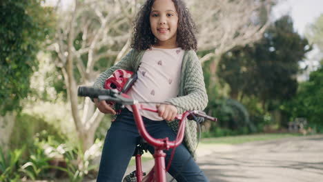 Child-on-a-bicycle-enjoying-her-fun-outdoor-hobby