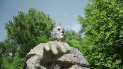 -View-from-below-of-a-bronze-statue-of-Baba-Vanga-or-Vangeliya-Pandeva-Gushterova-in-Rupite-Bulgaria,-who-was-a-Bulgarian-clairvoyant-or-more-commonly-known-as-the-Balkan-Nostradamus