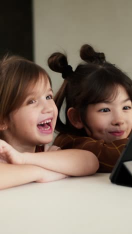 two girls looking at a tablet