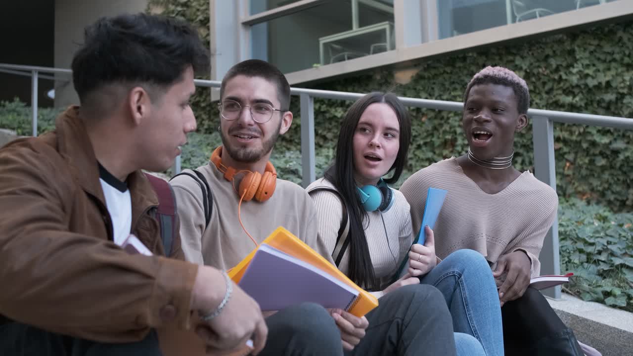 Transgender person and multiethnic group of students talking distracted sitting outdoors