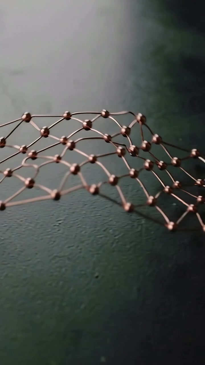 Vertical video: Moving camera revealing copper lattice on bench to show beads rings discs washers