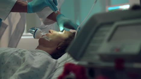 doctor checking patient oxygen mask with flashlight test in intensive care unit.