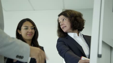 Cheerful-female-colleagues-working-in-office