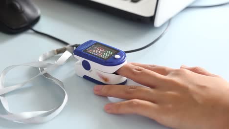 close-up video of a woman's finger measuring blood oxygen levels before receiving the corona virus vaccine