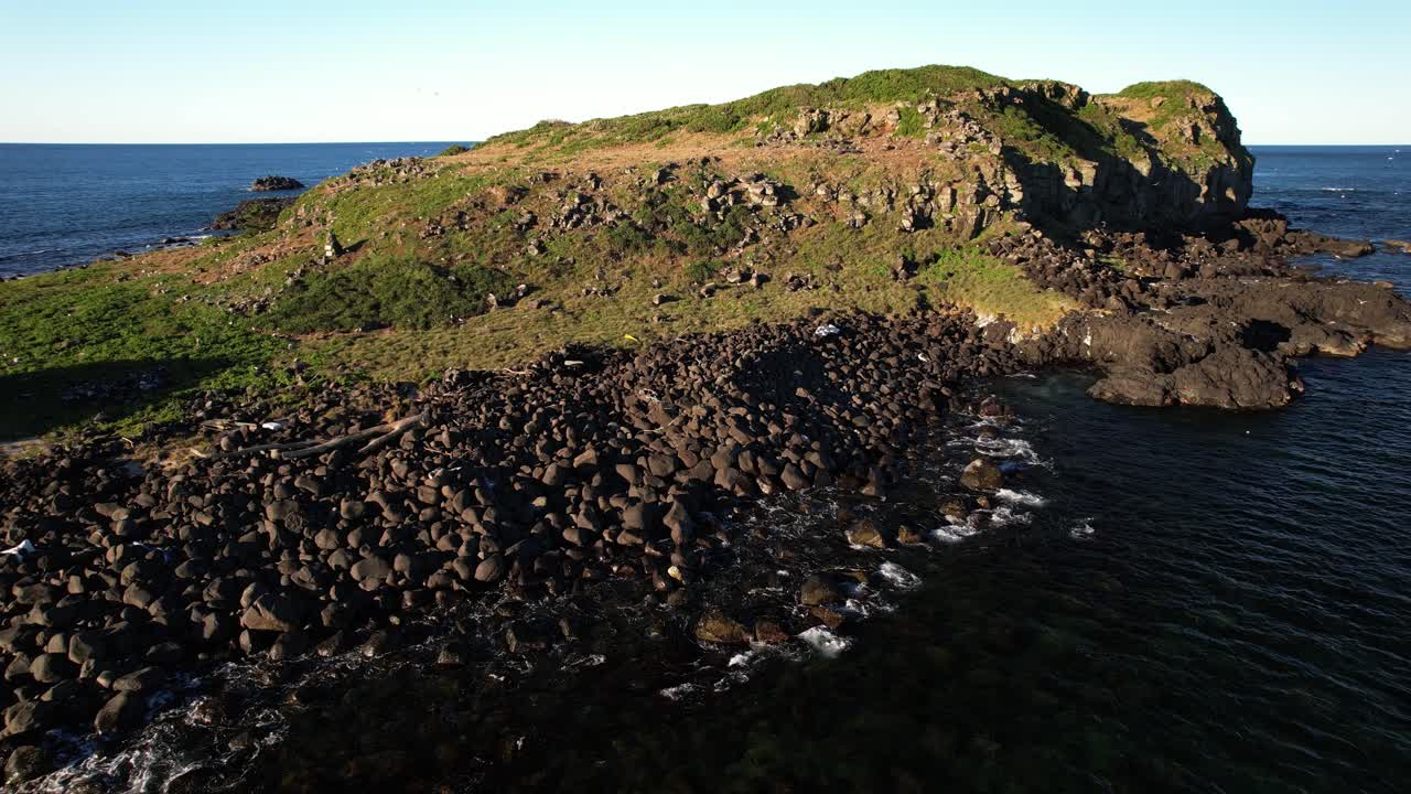 Rocky Shore Of Cook Island In NSW, Australia - Drone Shot
