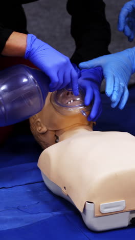 first medical help training equipment. medical dummy lays on blanket . practititoner puts oxygen mask. educational courses for medics. vertical video