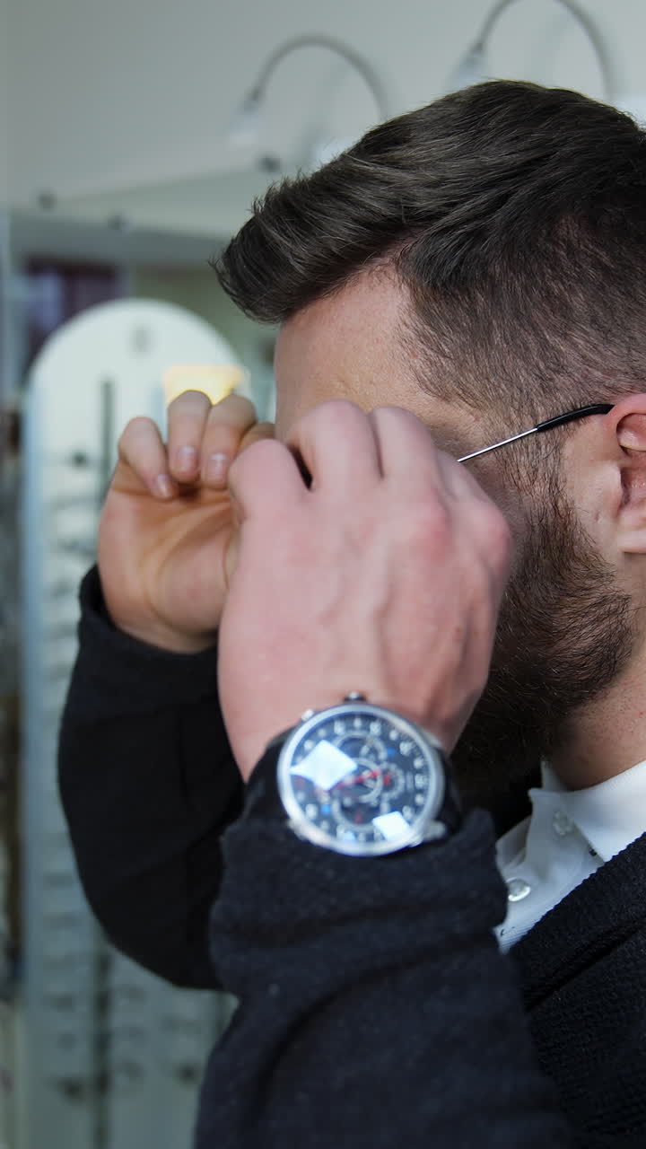 Man Trying on Eyeglasses in an Optical Shop
