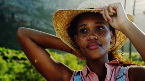 female hiker holding her hat in countryside 4k