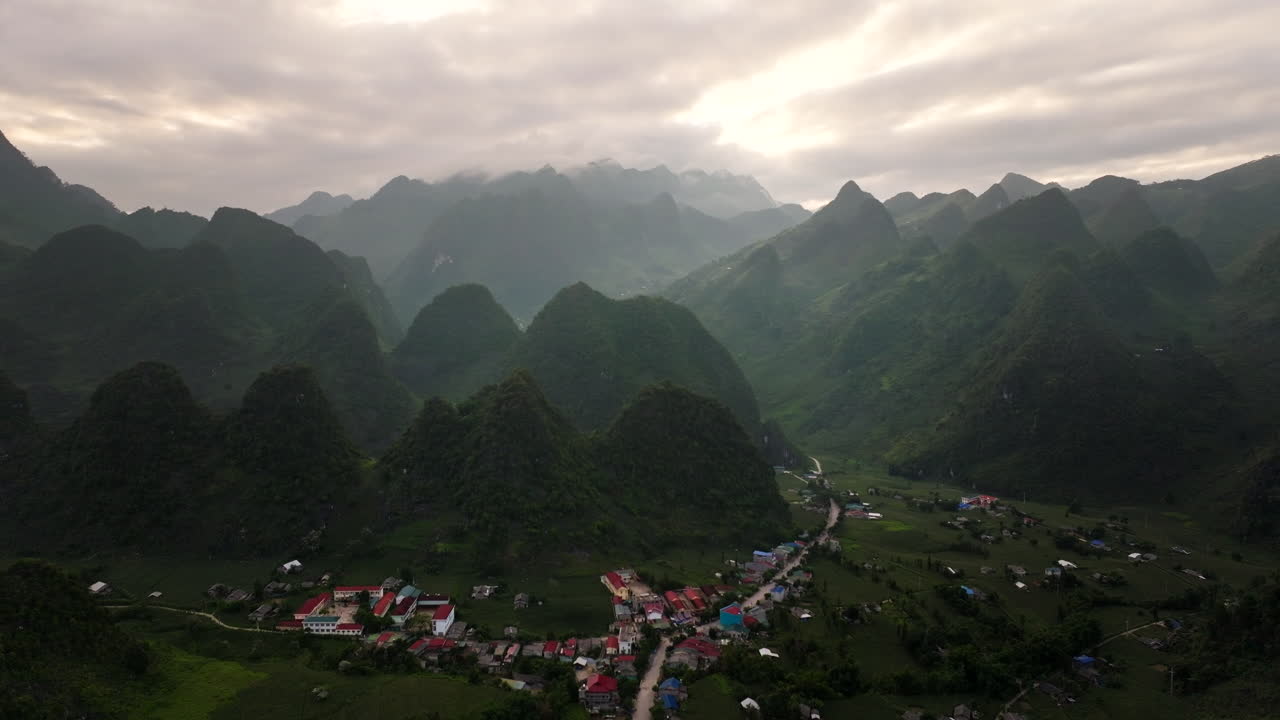Aerial panoramic view of Lung Hu commune, Ha Giant Loop tour scenic village and mountain landscape at sunrise