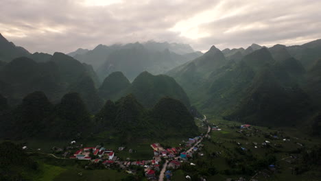 aerial panoramic view of lung hu commune, ha giant loop tour scenic village and mountain landscape at sunrise