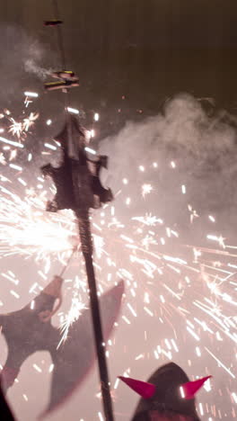 crowds in the street for the fire run or correfoc, during la merce festival,barcelona spain in vertical