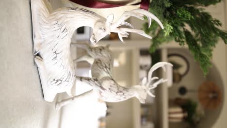 beautiful christmas sculpture decorations of deer on interior shelf