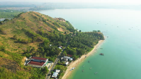 aerial flyover shot of gerupuk bay, with fishing harbor in lombok during sunny day