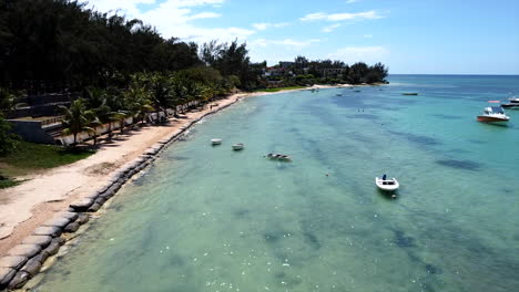 Flying-along-mauritian-seaside-beach-promenade-on-sunny-day,birds-eye-aerial