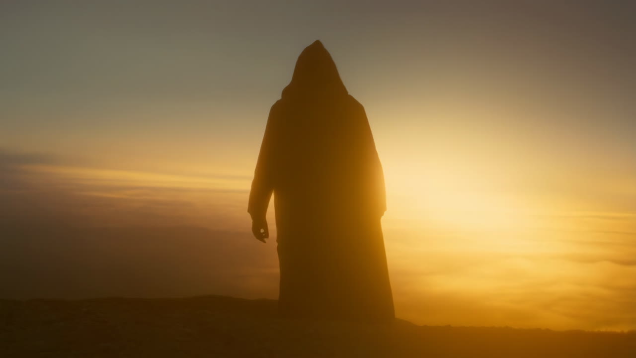 Mysterious Hooded Figure Silhouetted Against a Golden Sunset
