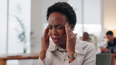 stressed woman with headache at the office