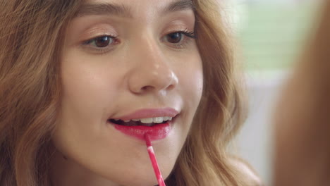 young woman using liquid lipstick