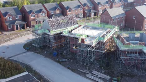 aerial view panning across new build housing framework on construction site development