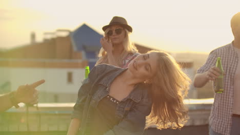 dancing girl rooftop party slow motion group of multiracial friends hanging out young asian woman dancing enjoying roof top event at sunset drinking alcohol having fun on weekend celebration